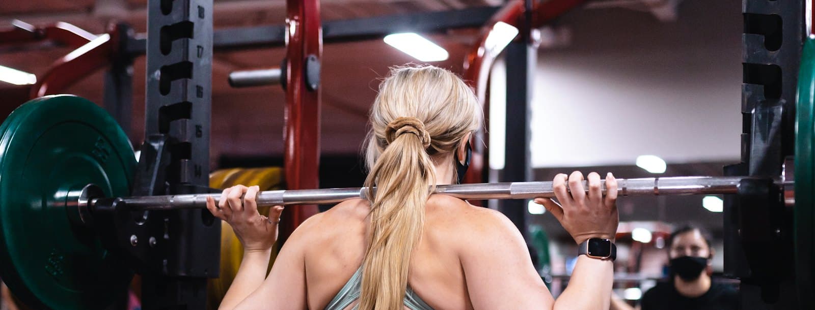 A lifter training with a barbell in a gym