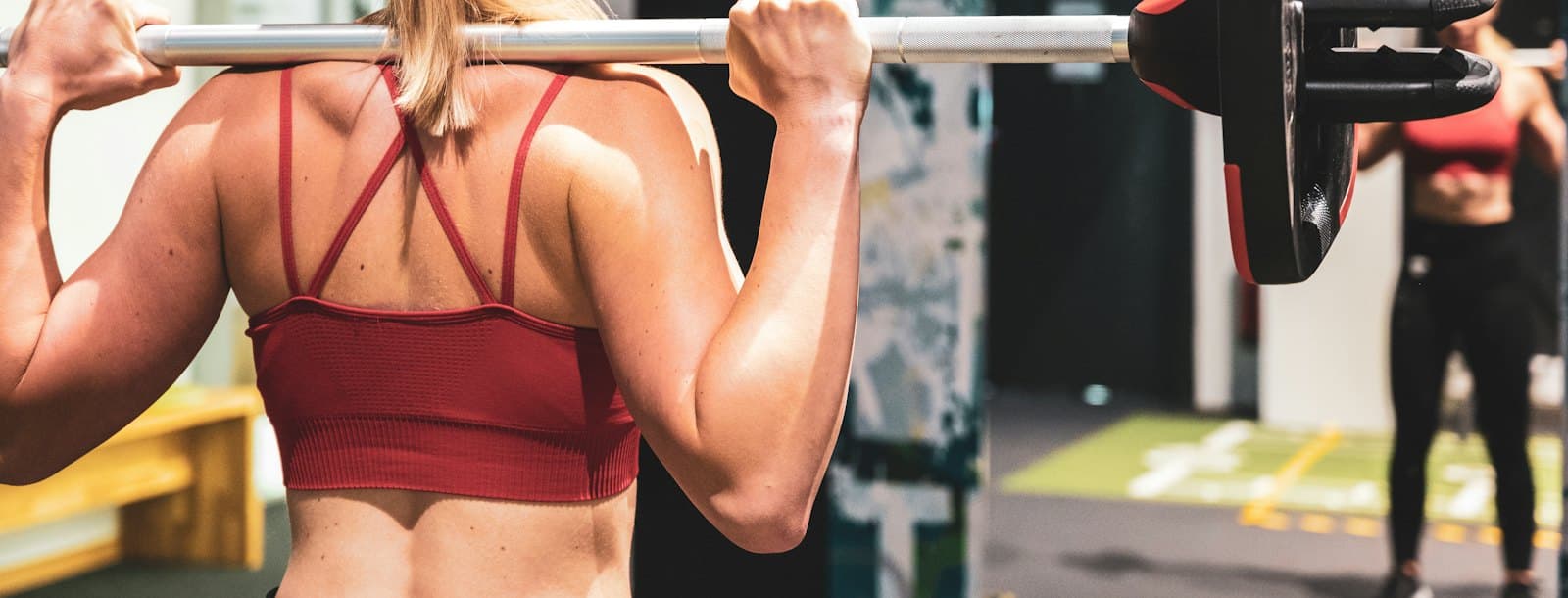A woman lifting a barbell during a training session