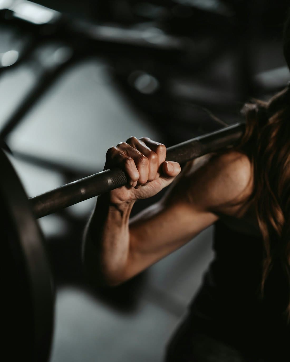 A lifter driving a loaded barbell up out of the bottom of a squat